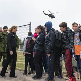 The Governor General chats with a group of youth. 