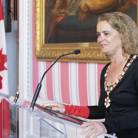The Governor General delivers remarks at a podium.