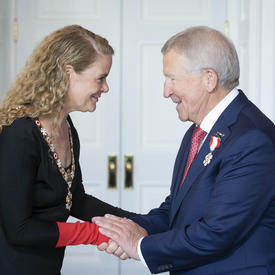 Jean-Pierre Léger shakes hands with the Governor General.