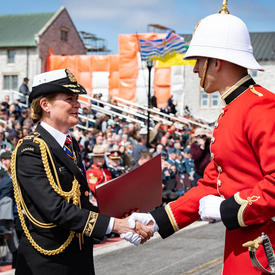 The Governor General hands commissioning scrolls to a member of RMC.