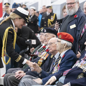 The Governor General shakes hands with veterans. 