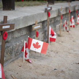 Crosses and Canadian flags in a row. 