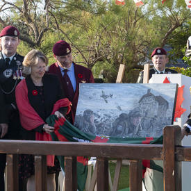 The Governor General unveils a painting that depicts the Battle of Normandy. 