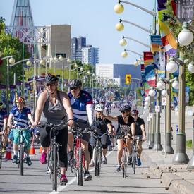 The governor general cycles along Sussex Drive with other participants