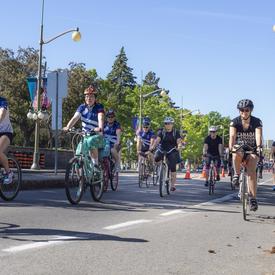 The Governor General cycles along Sussex Drive alongside Navy Bike Ride participants
