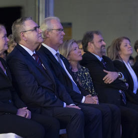 The Governor General sits among attendees at the unveiling of stamps celebrating Apollo 11 event.