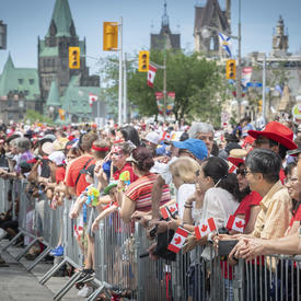 The streets of Ottawa are filled with crowds of people. 