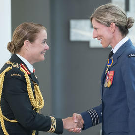 Lieutenant-Colonel Catherine Jocelyne Marchetti shakes hands with the Governor General.