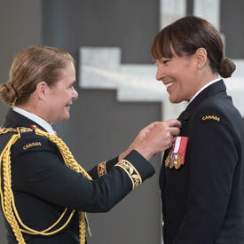 Commander Kelly Williamson accepts her medal from the Governor General.