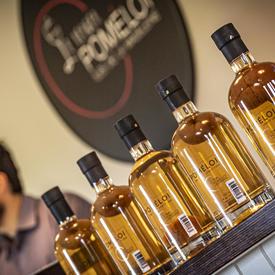 A photo of Verger Poméloi cider bottles lined up, sealed and ready for distribution.