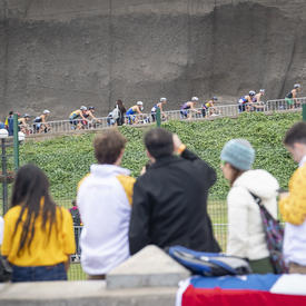 Men’s triathletes rode uphill on their bikes. 