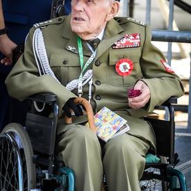 A photo of a Polish veteran in a wheelchair at the commemorative ceremony.