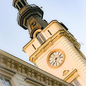A photo of a clock tower in Warsaw, Poland.