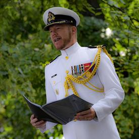 A Canadian Officer reads a citation during a Presentation of Canadian Honours Ceremony.