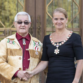 The Governor General shakes hands with a recipient during an Order of Canada ceremony.