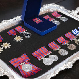 A photo of mixed honours medals, organized on a tray.