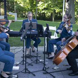 A photo of Canadian Armed Forces musicians playing during a Mixed Honours ceremony outside Rideau Hall.