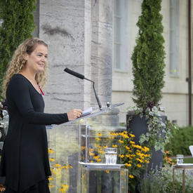 The Governor General delivers remarks at a podium.