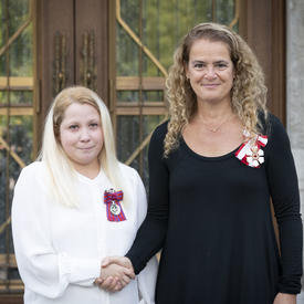 The Governor General shakes hands with a recipient during the Mixed Honours ceremony.