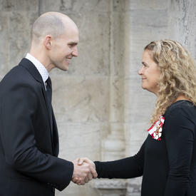 The Governor General shakes hands with a recipient during the Mixed Honours ceremony.