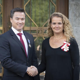 The Governor General shakes hands with a recipient during the Mixed Honours ceremony.