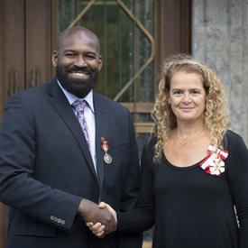 The Governor General shakes hands with a recipient during the Mixed Honours ceremony.