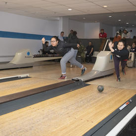 Members of the community bowling. 