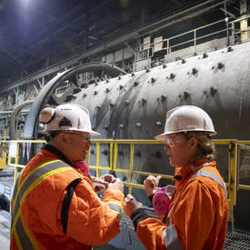 Governor General talking to Hudbay employee. 
