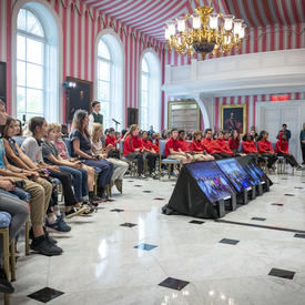 Over one hundred students and teachers sit and face the Governor General in the Tent Room of Rideau Hall as they engage in a question and answer session.