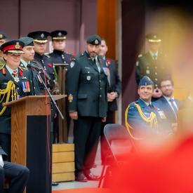 The Governor General delivers a speech at a podium during a Governor General's Foot Guards change of command ceremony. 