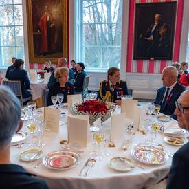 The Governor General sits and discusses with guests at the Luncheon for the National Silver Cross Mother. 