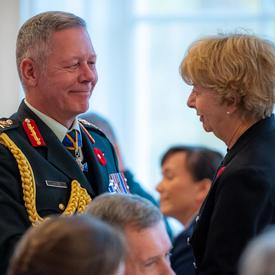 The Chief of the Defence Staff and the National Silver Cross Mother engage in conversation. 
