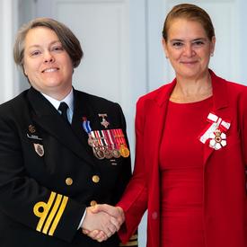 The Governor General shakes hands with Commander Burke. 