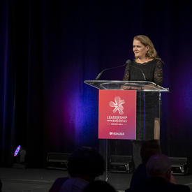 Governor General Julie Payette is speaking at a podium.