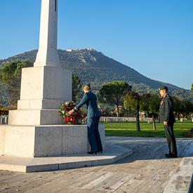 Governor General Julie Payette, wearing the Royal Canadian Air Force uniform, is laying a wreath at the Cassino War Cemetery.