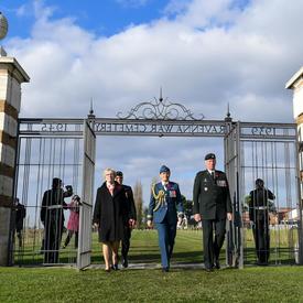 The Governor General enters the gates of the Ravenna War Cemetery.