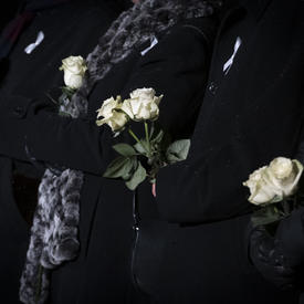 A photo of dignitaries holding white roses in honour of the 14 deceased women.