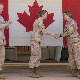The Governor General shakes hands with a CAF member. 