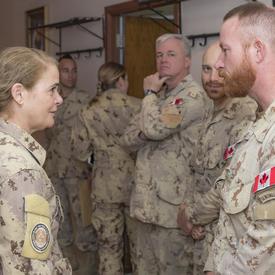 La gouverneure générale Julie Payette parle à un des membres des Forces armées canadiennes.