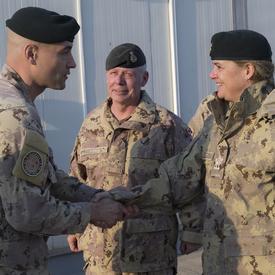 Governor General Payette shakes hands with a CAF member. General Jonathan Vance, Chief of the Defence Staff, is standing beside her. 
