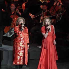 Two singers are performing on stage. 