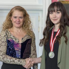  The Governor General is shaking Leah Baptiste’s hand. 
