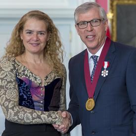 The Governor General is shaking Bill Waiser’s hand. 