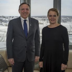 Quebec Premier François Legault and Canada's Governor General Julie Payette pose for a photo in front of a window of the Governor General's residence at La Citadelle. Winter view of the St. Lawrence River and the city of Lévis.