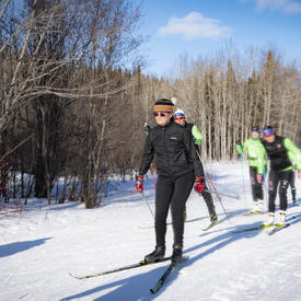 The Governor General cross country skis with competitive racers and youth.