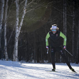 A competitive cross-country skier racing down a trail.