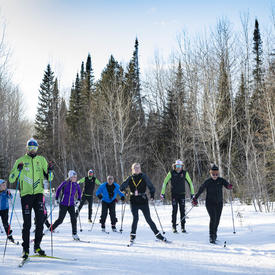 Competitive cross-country skiers racing down a trail.
