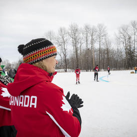 The Governor General cheers on Snowshoeing athletes during a race.