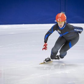 A speed skater takes a tight turn during a race at the Special Olympics.