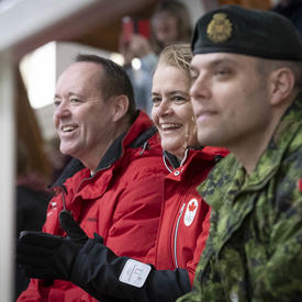The Governor General cheers on athletes during a tight speed skating race.